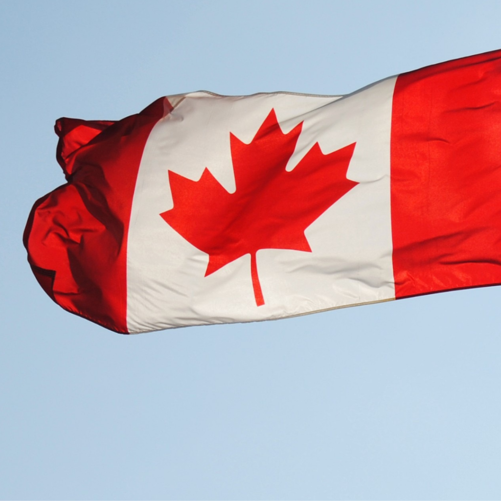 A canadian flag flapping proudly in the wind.